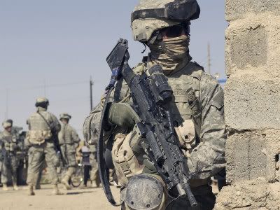 stocktrek-images-us-army-soldier-armed-with-a-mk-48-light-machine-gun-provides-rear-security-during-civil-affairs.jpg