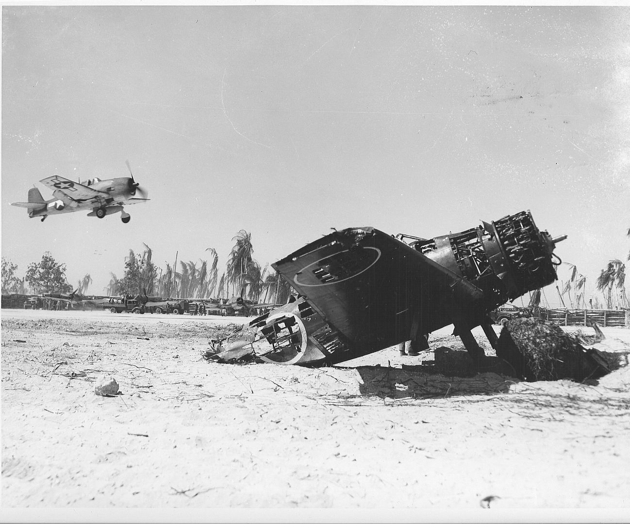 3HellcataircraftislandingonTarawaairstripAwreckedJapanesezeroisintheforeground